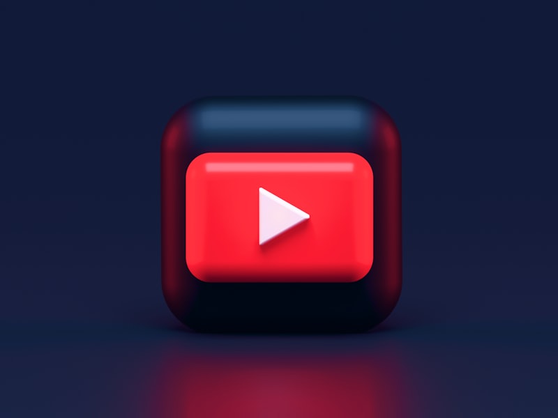 A 3D red play button icon on a dark blue background